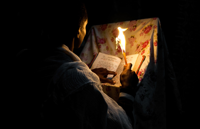 A orthodox deacon reading a bible in Lalibela (Ethiopia - 2017)