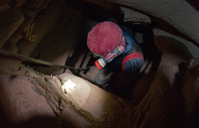 A miner is going underground in search of the precious metal.