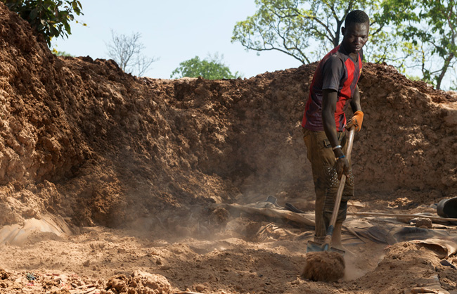A man is preparing the gravel to be crushed.