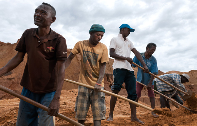 Workers at the Ilakaka mine, the largest sapphire mine in the world. Workers dig for several days and if the quantity and the quality of the sapphires is proven, they dig huge holes for months in search of the famous gems.