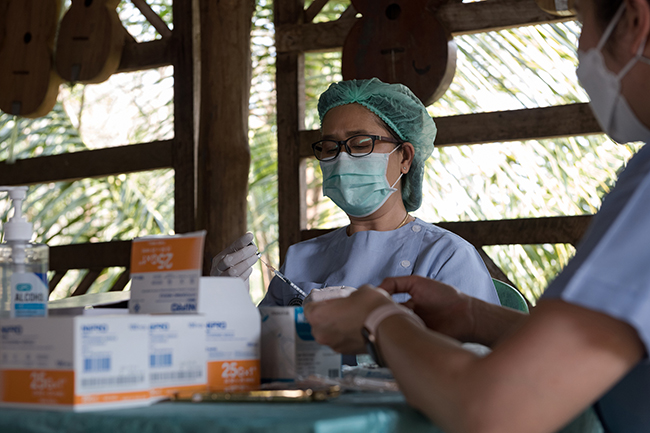The team of nurses in charge of the vaccination campaign in the village prepares the syringes for the messenger RNA vaccine. After two doses of the Sinopharm vaccine, the third injection of the long-awaited vaccine from the American firm Pfizer is seen as an opportunity to reopen their village to mass tourism and a return to life as it was before.