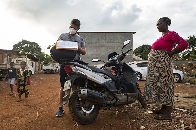 Clément, a private nurse, checks a pregnant patient directly in the street on the hills of Passamainty. Mayotte - 2021