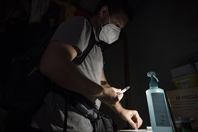 In a house without electricity, Clément, a private nurse in Mayotte, prepares an insulin injection using the light from his mobile phone. Mayotte - 2021