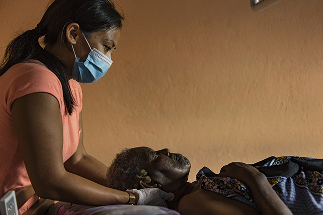 The massages given by Pauline, a physiotherapist in Mayotte, are essential for the daily comfort of this bedridden and isolated woman. Mayotte - 2021
