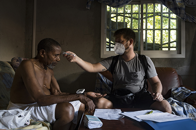 Clément, a private nurse in Mayotte, examines his patient. Mayotte - 2021