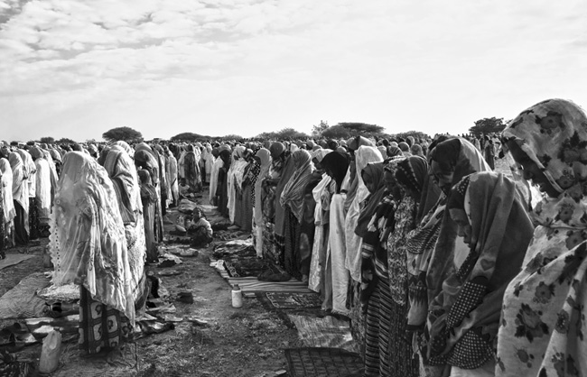 Women dressed in colorful outfits during the great prayer of Eid in front of the village’s school.