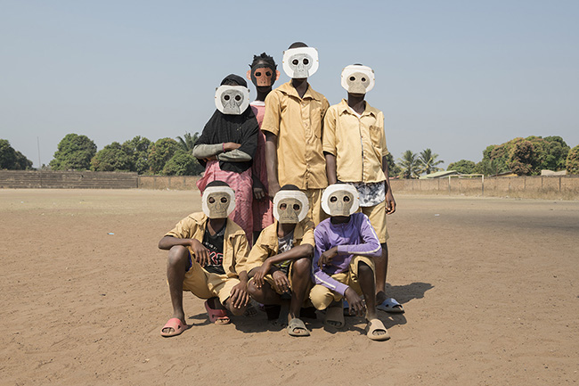 Portrait of students from Alpha Yaya School in Faranah wearing primate masks during a role-playing game organized by the Chimpanzee Conservation Center to raise awareness about the protection of chimpanzees and their habitat.